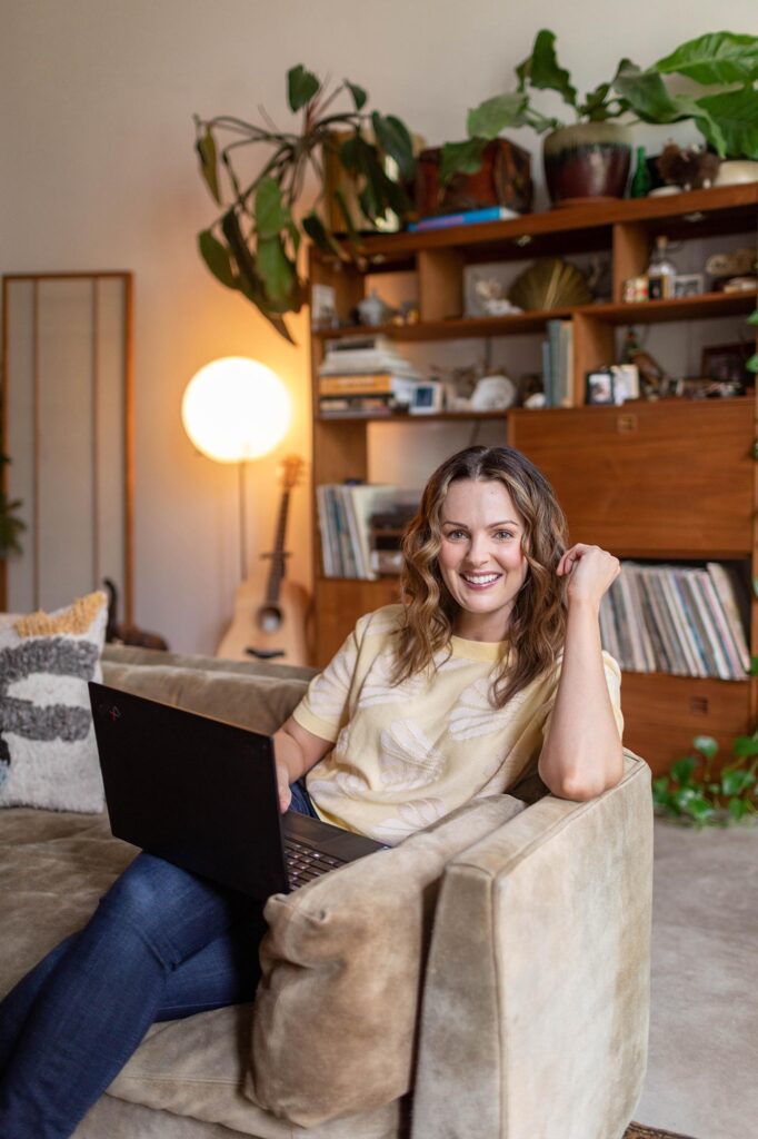 Kara Francis smiling & working on the laptop